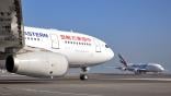 china eastern airlines widebody aircraft foreground on tarmac and emirates airline widebody in background taxiing