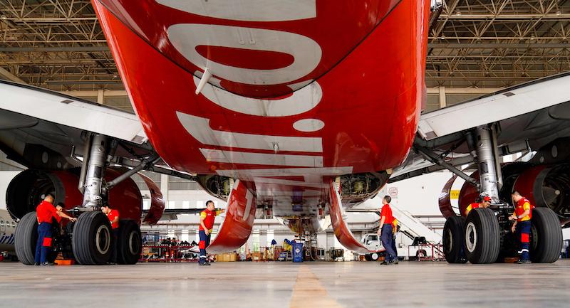 vietjet plane in hangar with maintenance workers